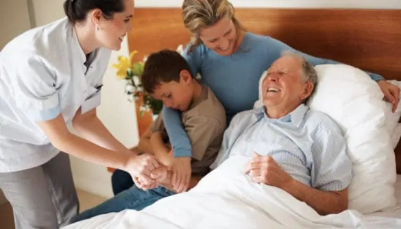 Home Health Aide Assisting Hospice Patient and Family
