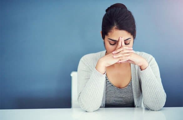 Lady sitting down stressed out about Hospice Care