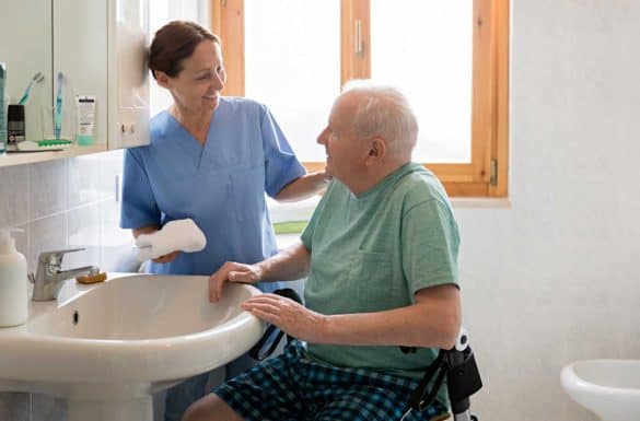 Nurse bathing hospice patient