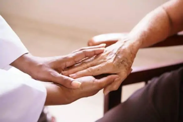 Hospice Doctor Holding Hand of Hospice Patient